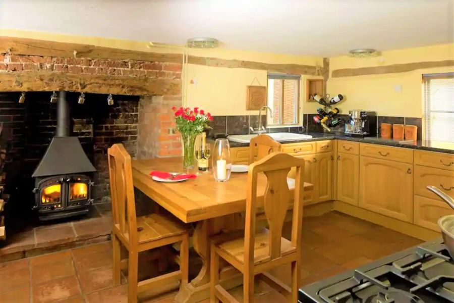 Kitchen with large inglenook fireplace.
